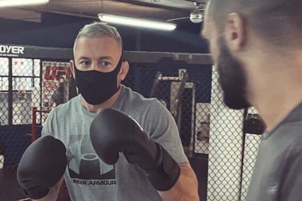 Former UFC two-weight champion Georges St-Pierre trains with a mask and boxing gloves ahead of his announcement of a new team next year. Photo: Twitter/Georges St-Pierre