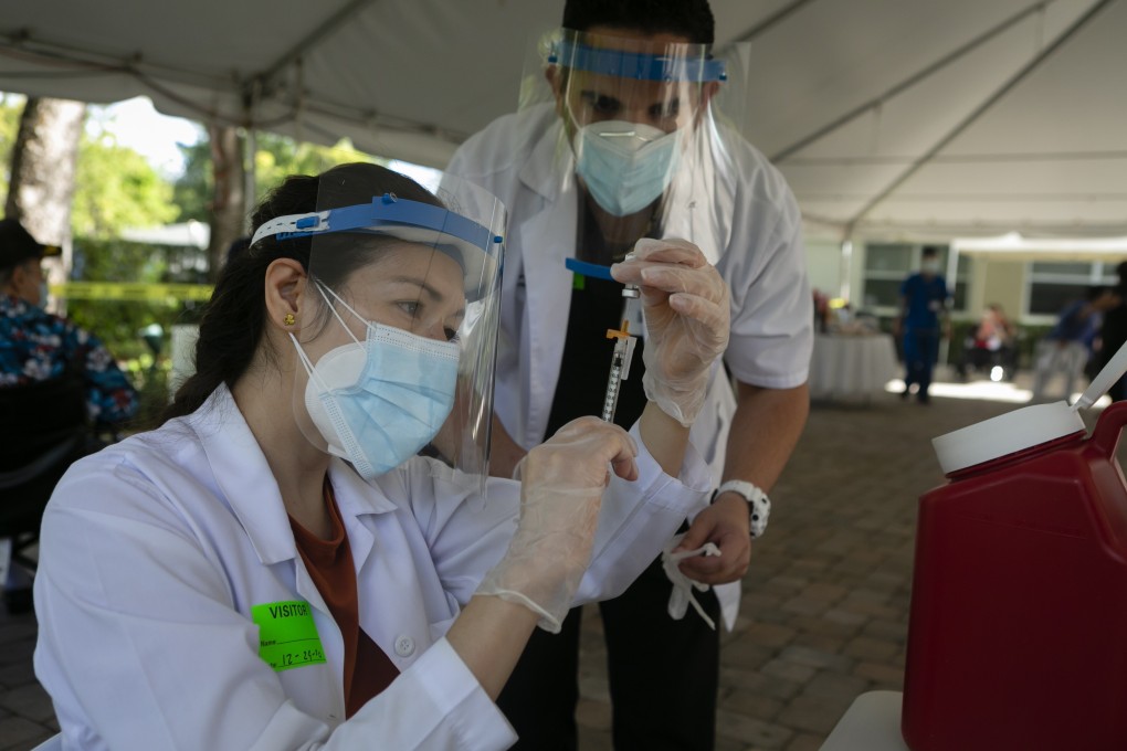 A health worker prepares to administer a dose of the Pfizer-BioNTech Covid-19 vaccine to the residents of The Palace Nursing and Rehabilitation Centre in Miami, Florida. Photo: Bloomberg