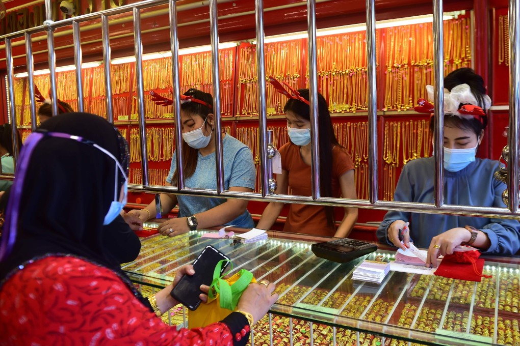 A customer at a gold shop in the southern Thai province of Narathiwat. Photo: AFP