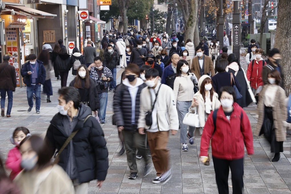 People wearing face masks walk in Tokyo’s Ikebukuro area on Wednesday. Photo: Kyodo