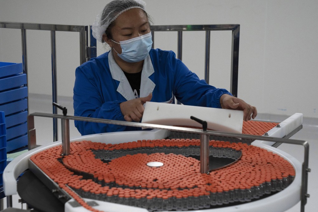 A worker loads vials to be used in the production line for a Covid-19 vaccine at Chinese company Sinovac in Beijing. Photo: AP
