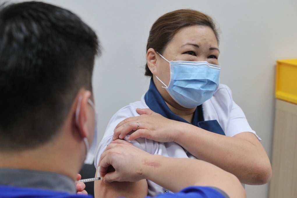 Staff Nurse Sarah Lim receives the vaccine at the National Centre for Infectious Diseases. Photo: AFP/Singapore’s Ministry of Communications and Information