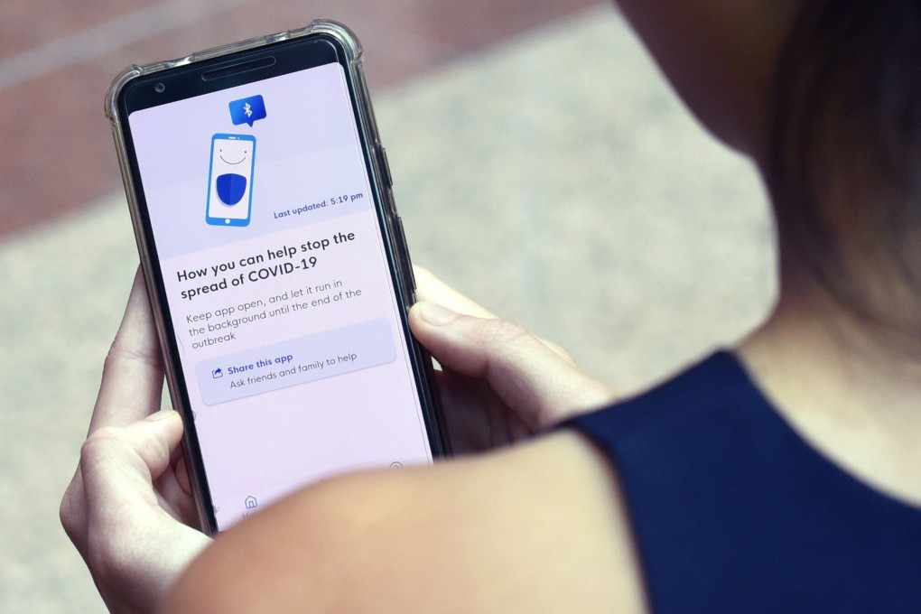 A staff member from Singapore’s Government Technology Agency demonstrates the TraceTogether contact-tracing app. Photo: AFP