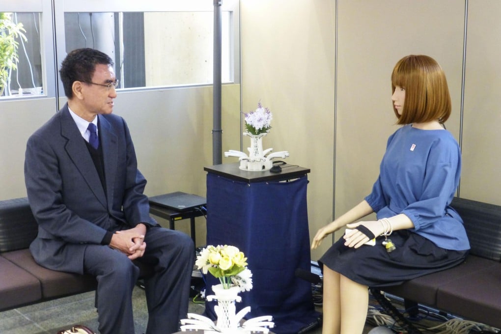 Taro Kono, the Japanese minister in charge of administrative reform, talks to an AI-equipped humanoid robot on December 20, during a visit to the Advanced Telecommunications Research Institute International in Seika, Kyoto. Photo: Kyodo