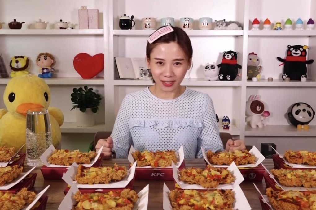 Mizijun, a female vlogger previously known as Big Stomach Mizijun and one of the pioneers of mukbang, or binge-eating, in China, about to attempt to eat a large quantity of “Chizza” chicken pizza from KFC in a video from her YouTube channel. Photo: YouTube / Mizijun