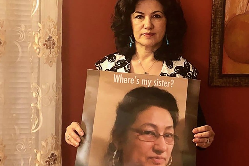 Rushan Abbas holds up a photo of her sister, Gulshan Abbas. Rushan says Gulshan is being punished by China for her siblings’ acitivism in America. Photo: Handout