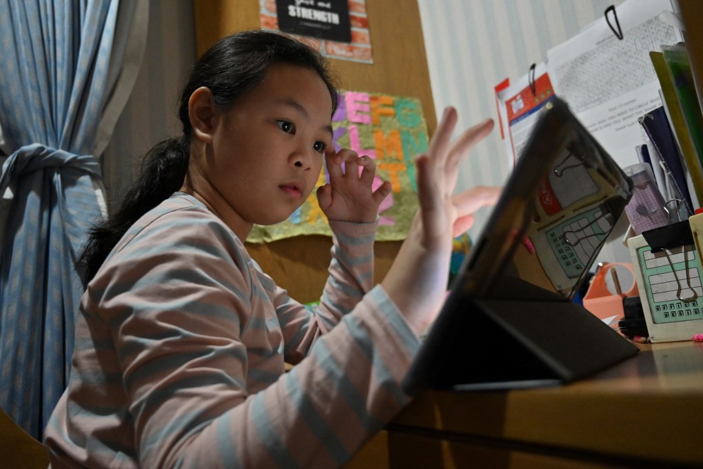 A girl uses a tablet to complete her schoolwork at home in Bangkok on May 10. More than a billion children worldwide have seen their school and home life upended by the coronavirus pandemic, according to a UN agency. Photo: AFP