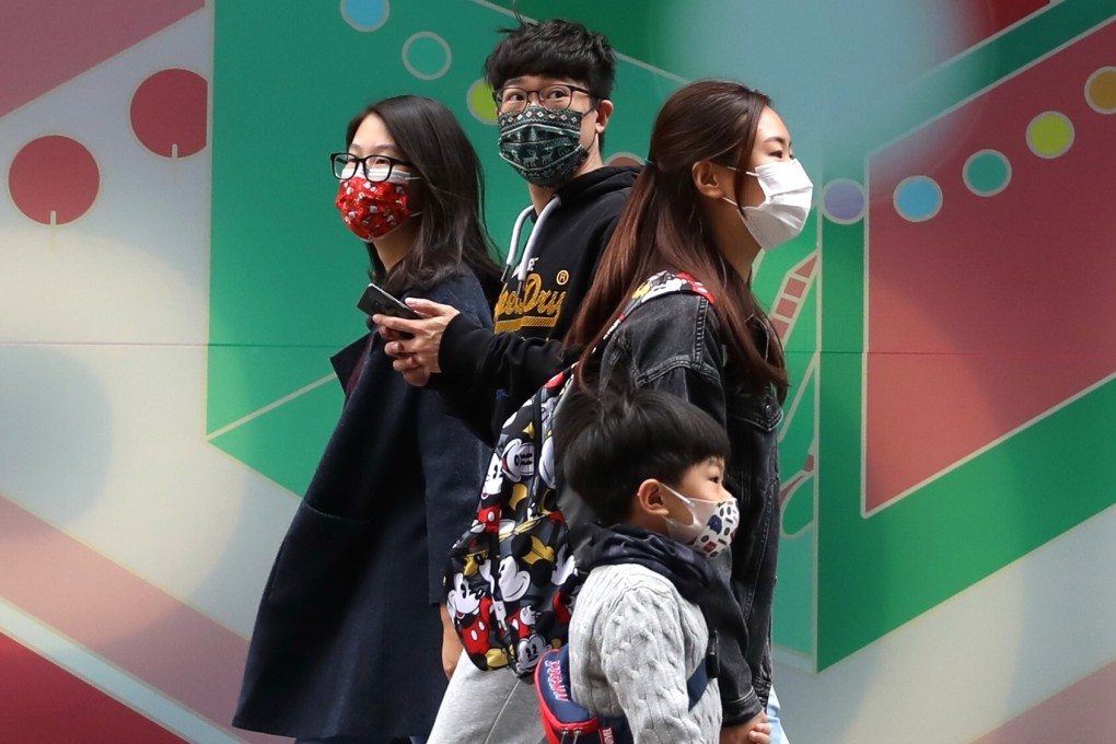 People wearing face masks are seen on a street in Hong Kong on December 25. Hongkongers who share the common goal of achieving democracy should live up to its principles and respect diverse opinions. Photo: Xinhua