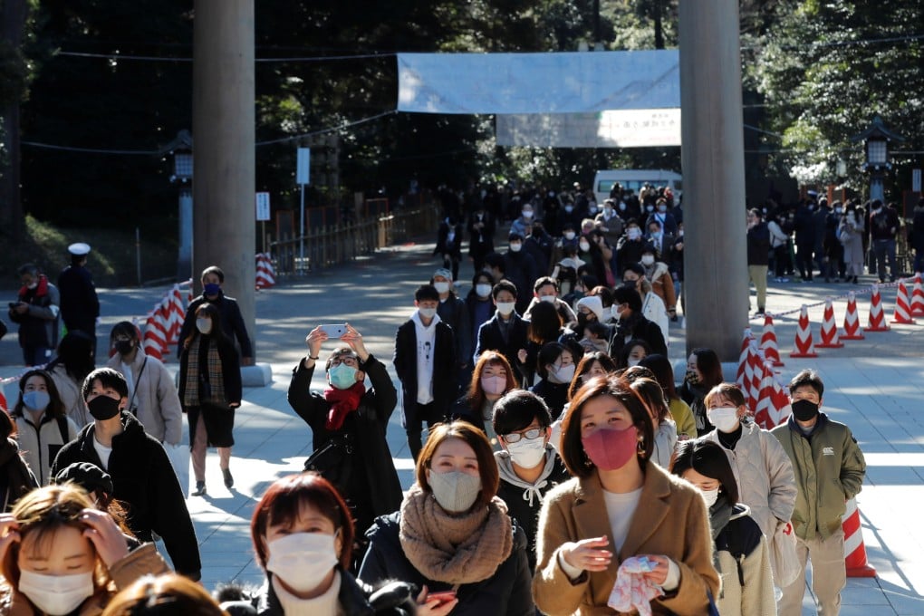 Japanese in protective masks walk to pray on the first day of the new year at the Meiji Shrine in Tokyo, Japan, on Friday. Photo: Reuters