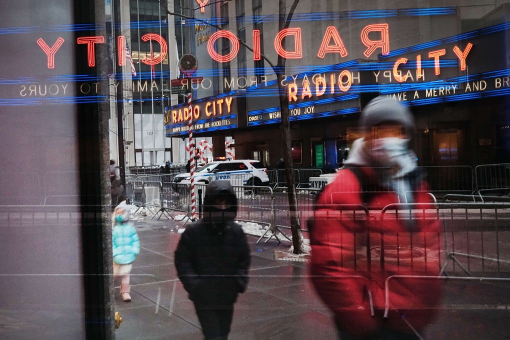 People walk through the Rockefeller Centre in a subdued New York City on December 20. The resurgent pandemic has caused an economic slowdown in the US. Photo: AFP