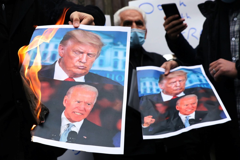Iranian protesters burn pictures of Biden and Trump during a November 28 demonstration against the killing of the country’s top nuclear scientist, Mohsen Fakhrizadeh. Photo: Reuters