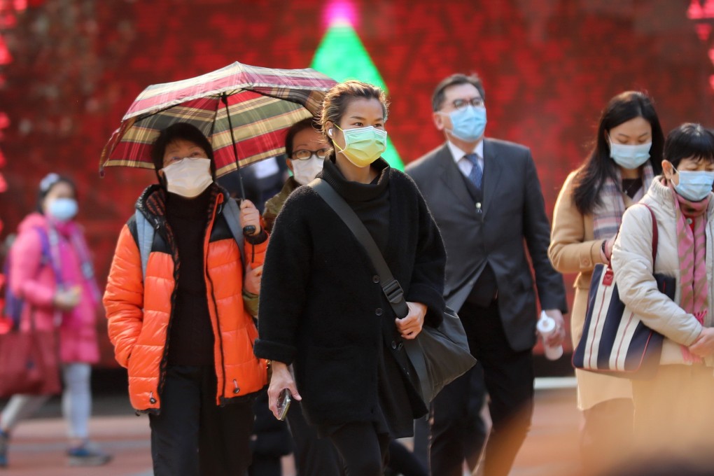 Residents wearing face masks bundle up against the cold. Photo: Xinhua