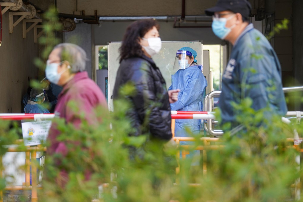 Residents queue for Covid-19 testing at a specimen collection station at Ping Shek Estate following a number of confirmed cases there. Photo: Winson Wong