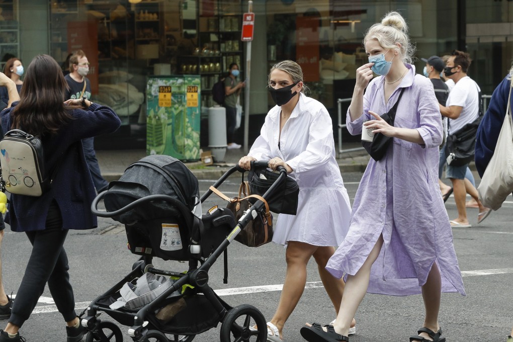 Shoppers wear masks as they walk around a shopping area in Sydney, Australia, on Sunday. Masks have been made mandatory in shopping centres, on public transport, and in entertainment venues such as a cinemas, and fines will come into effect on Monday. Photo: AP