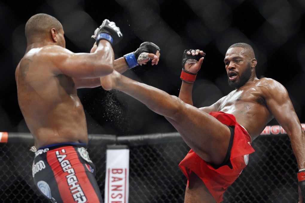 Jon Jones kicks Daniel Cormier during their light heavyweight title bout at UFC 182 in Las Vegas. Photo: AP