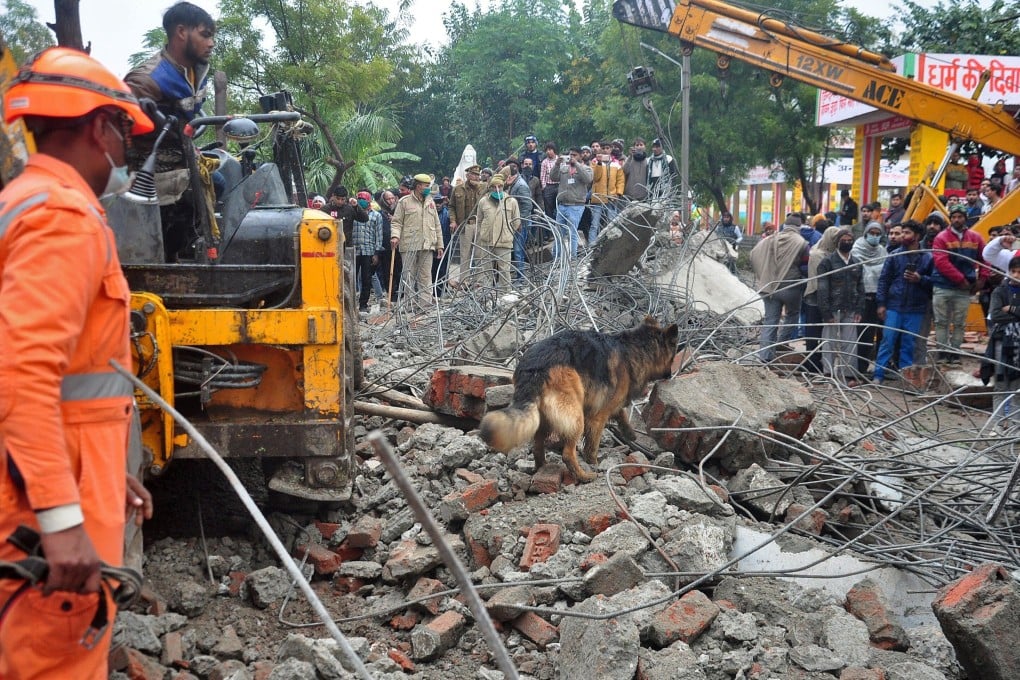A sniffer dog examines the debris after the roof of a shelter at a crematorium collapsed in Ghaziabad, India, on Sunday. Photo: Reuters