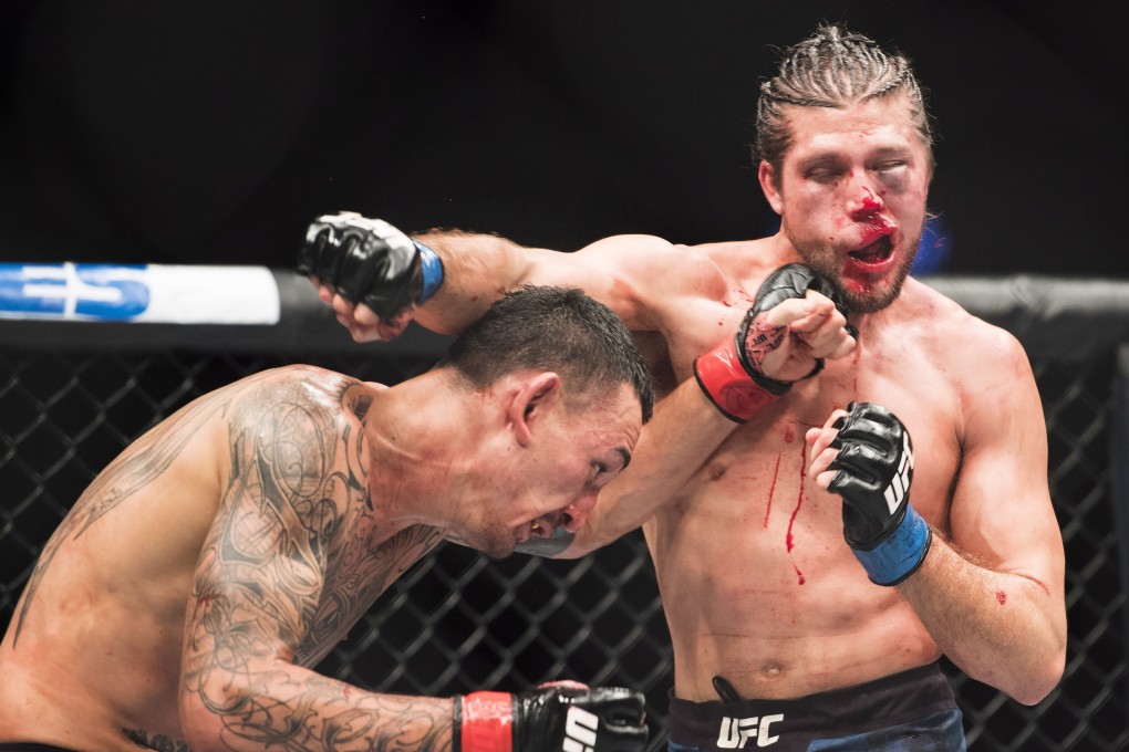 Max Holloway punches Brian Ortega en route to retaining his featherweight title via TKO on a medical stoppage at UFC 231. Photo: AP