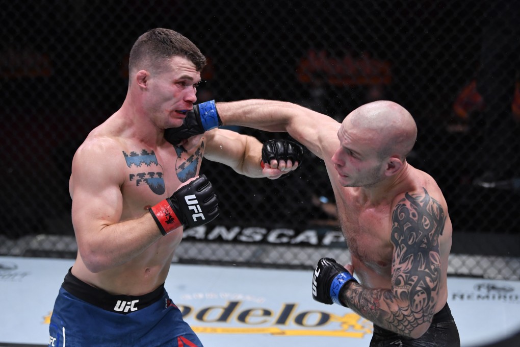 Sasha Palatnikov punches Louis Cosce in their welterweight bout during UFC 255. Photo: Jeff Bottari/Zuffa LLC
