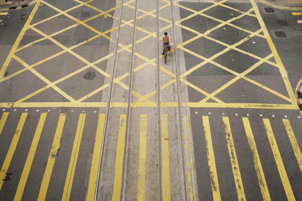 A cyclist makes his way down Hong Kong’s business district of Central on January 4. The economic downturn and Covid-19 restrictions have caused a drastic cutback in internship opportunities for university students in the city. Photo: Xinhua