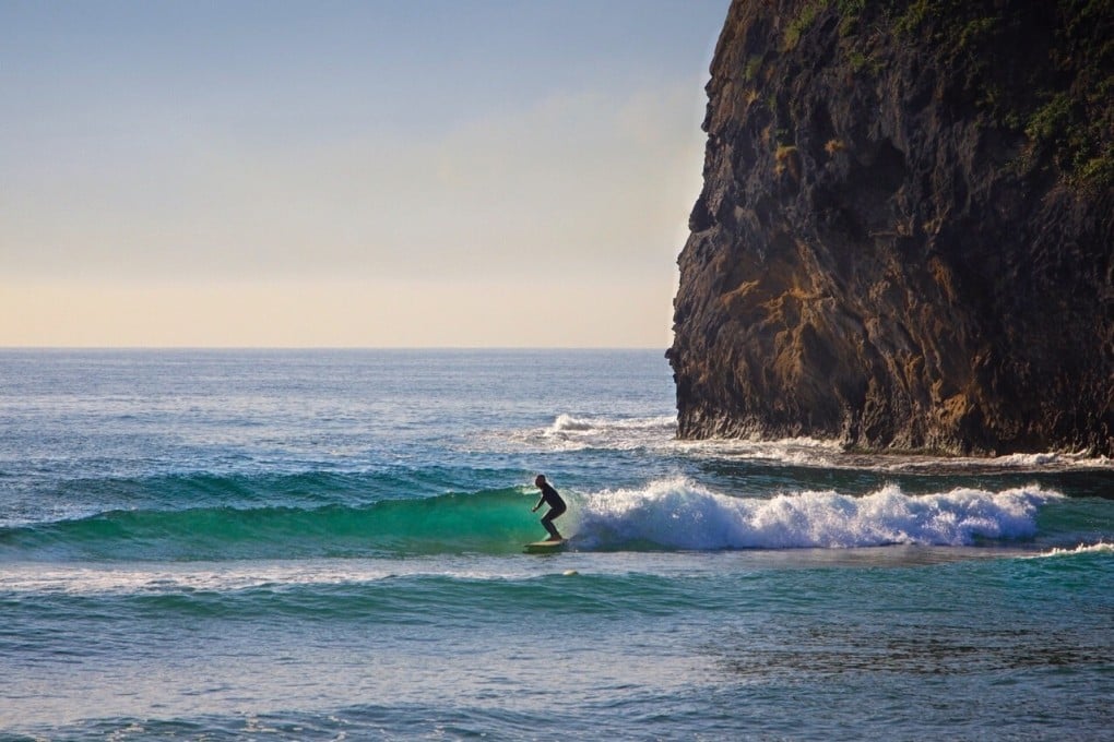Nicola Zanella surfing in North Korea at Majon beach resort. He first spotted a wave in North Korea on Google Earth. Photo: Uri Tours