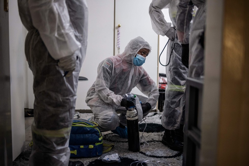 South African paramedics assess a Covid-19 patient in Lenasia, Johannesburg, on Monday. Photo: AFP