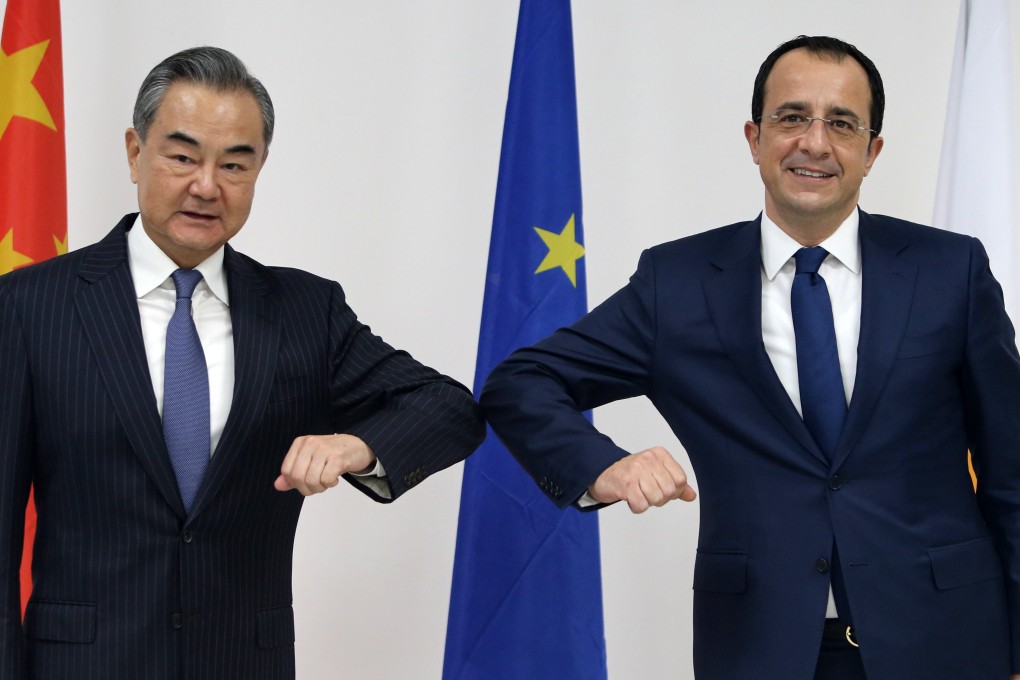 Chinese Foreign Minister Wang Yi (left) and his Cypriot counterpart Nikos Christodoulides exchange greetings on Monday. Photo: EPA-EFE