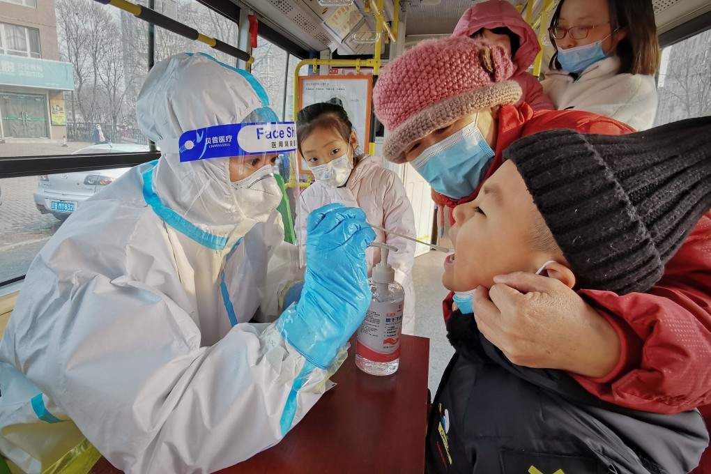A child gets tested in Dalian, northeast China, in December. A WHO team has not yet been granted entry to the country to investigate the origins of Covid-19. Photo: AFP