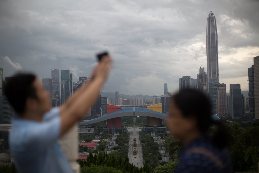 People take photos at a panoramic lookout in Shenzhen, part of the Greater Bay Area. Photo: EPA