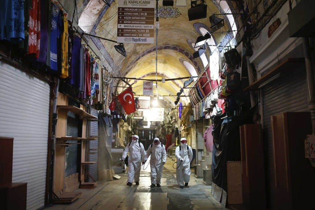Municipality workers in protective suits spray disinfectant at the iconic Grand Bazaar in Istanbul amid the coronavirus pandemic. Photo: AP