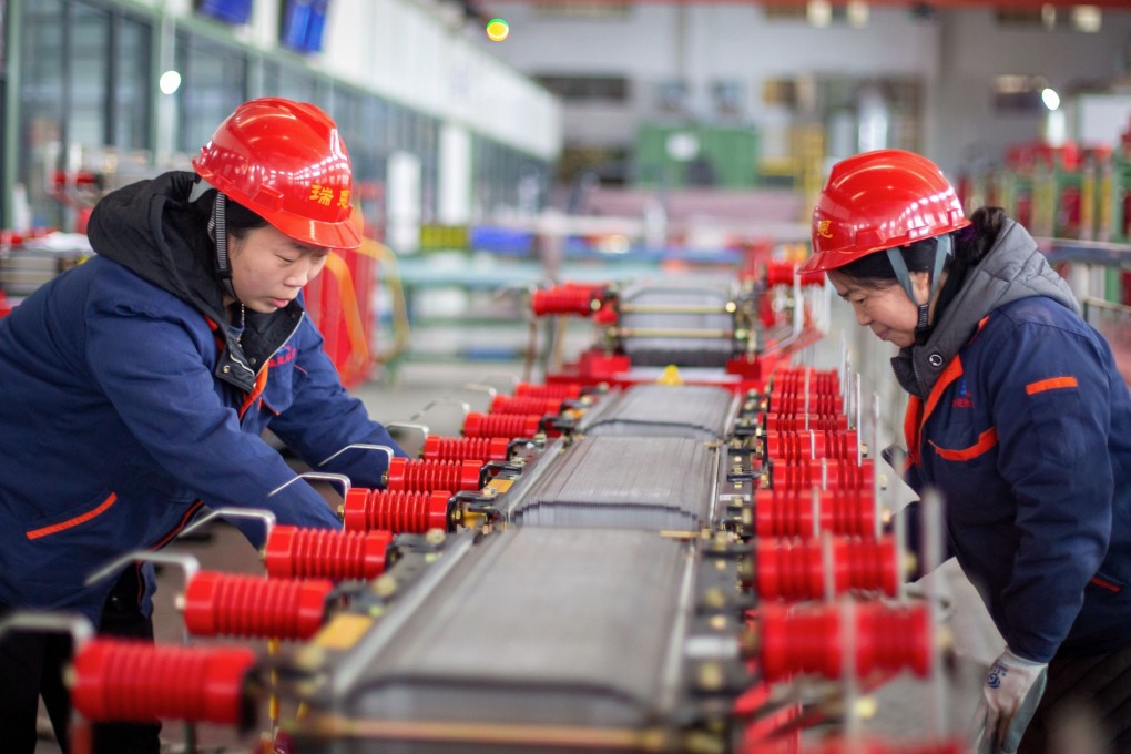 Employees work on a production line at a factory in Jiangsu on Monday. Photo: AFP