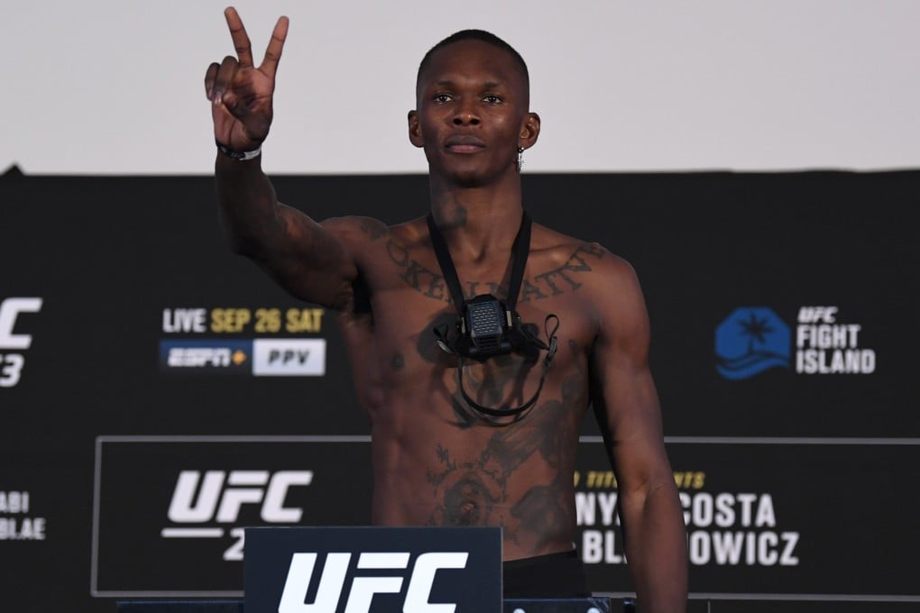 Israel Adesanya poses on the scale during the UFC 253 weigh-in. Photo: Josh Hedges/Zuffa LLC via Getty Images