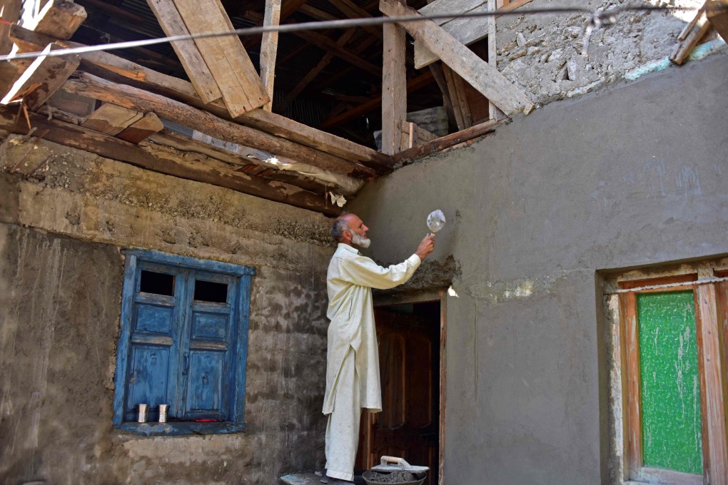 A labourer plasters a wall during the reconstruction of a portion of the house that was damaged following a shelling between Pakistan and Indian security forces in Jura, Neelum Valley of Pakistan-administered Kashmir. Photo: AFP