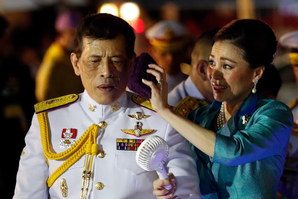 Queen Suthida wipes the sweat off the face of Thai King Maha Vajiralongkorn as they greet to well-wishers in Bangkok in November. Photo: EPA-EFE