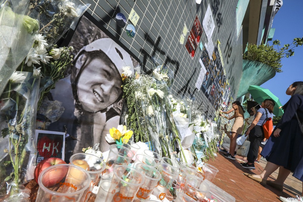 People lay flowers at a memorial for student Chow Tsz-lok, who died after suffering a fall during a police clearance operation in 2019. Photo: Felix Wong