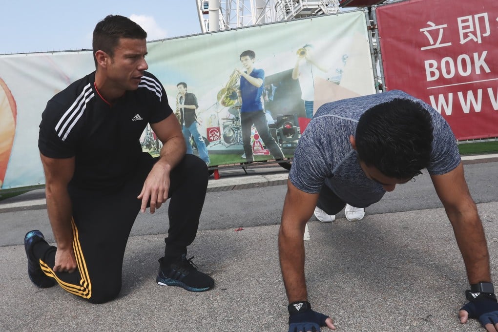 Personal trainer Ozgur “Ozzy” Irier hosts a personal training session with a client. Photo: Jonathan Wong