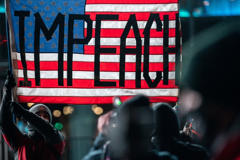 Demonstrators in Brooklyn, New York City, hold up a US flag during a rally on January 7 calling for President Donald Trump to be impeached, a day after his supporters stormed the Capitol. Photo: Reuters
