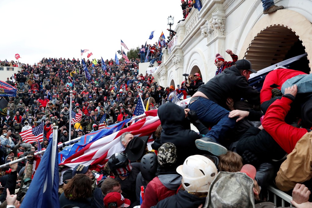 Pro-Trump protesters storm into the US Capitol during clashes with police on Wednesday. Photo: Reuters