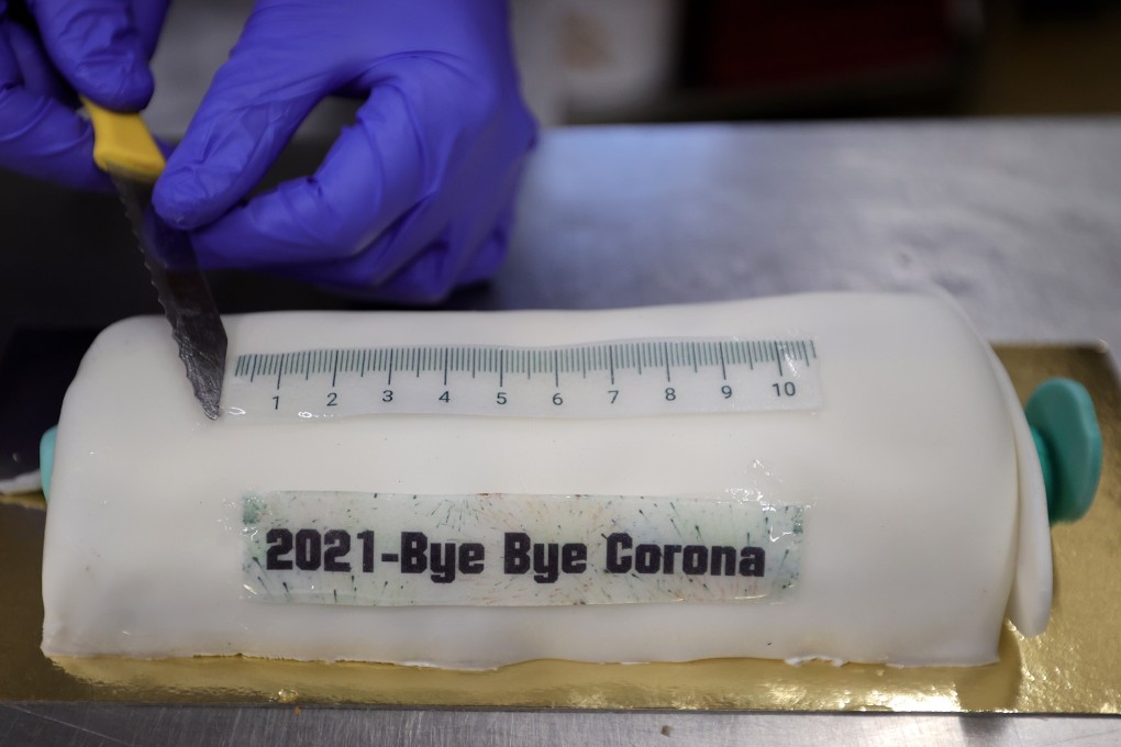 A vaccine syringe-shaped cake with the inscription “2021-Bye Bye Corona” at the Schuerener Backparadies bakery in Dortmund, Germany. Photo: EPA-EFA