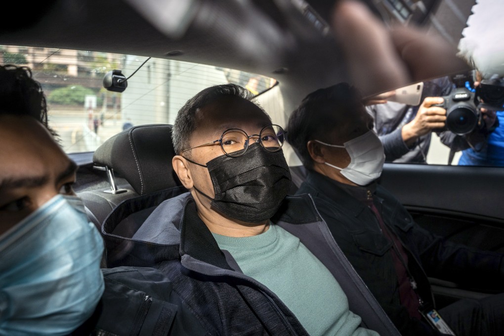 Pro-democracy activist Benny Tai (centre) arrives at Ma On Shan police station after being arrested on January 6. Photo: Bloomberg