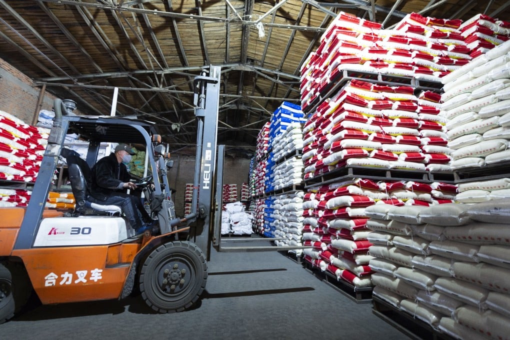 A worker loads packaged grains at a rice-processing company in northeast China’s Heilongjiang Province. Photo: Xinhua