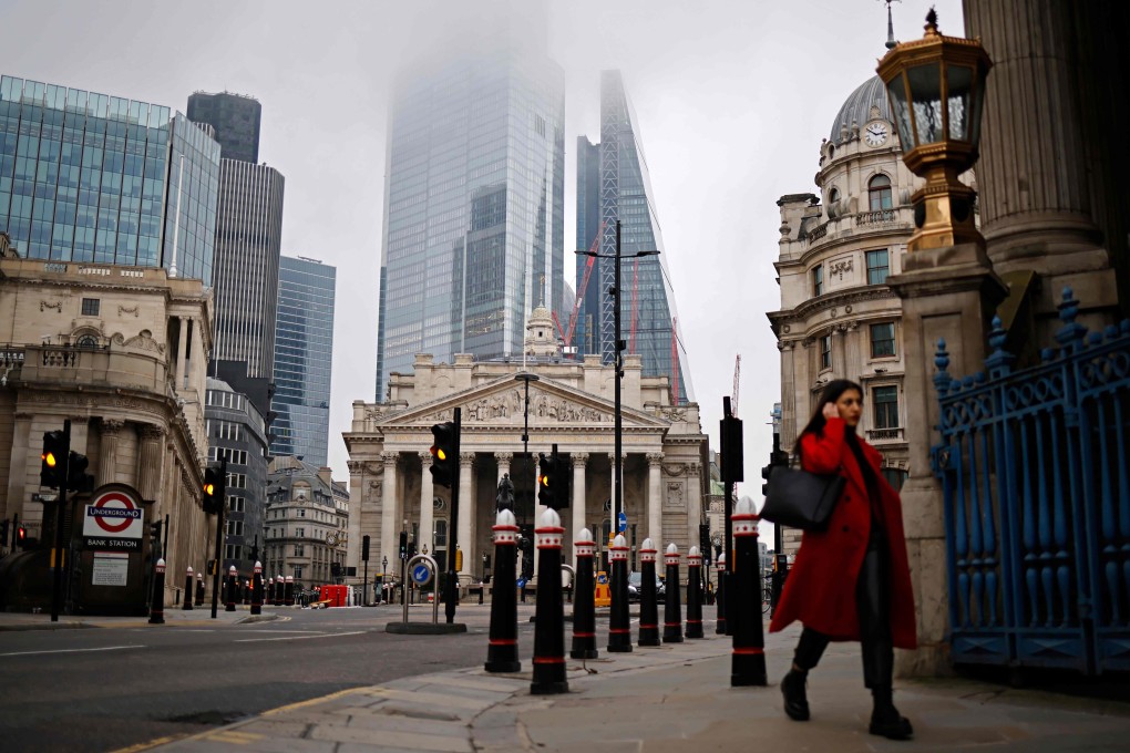 A pedestrian walks near the Royal Exchange and the Bank of England in the City of London amid a lockdown. Photo: AFP