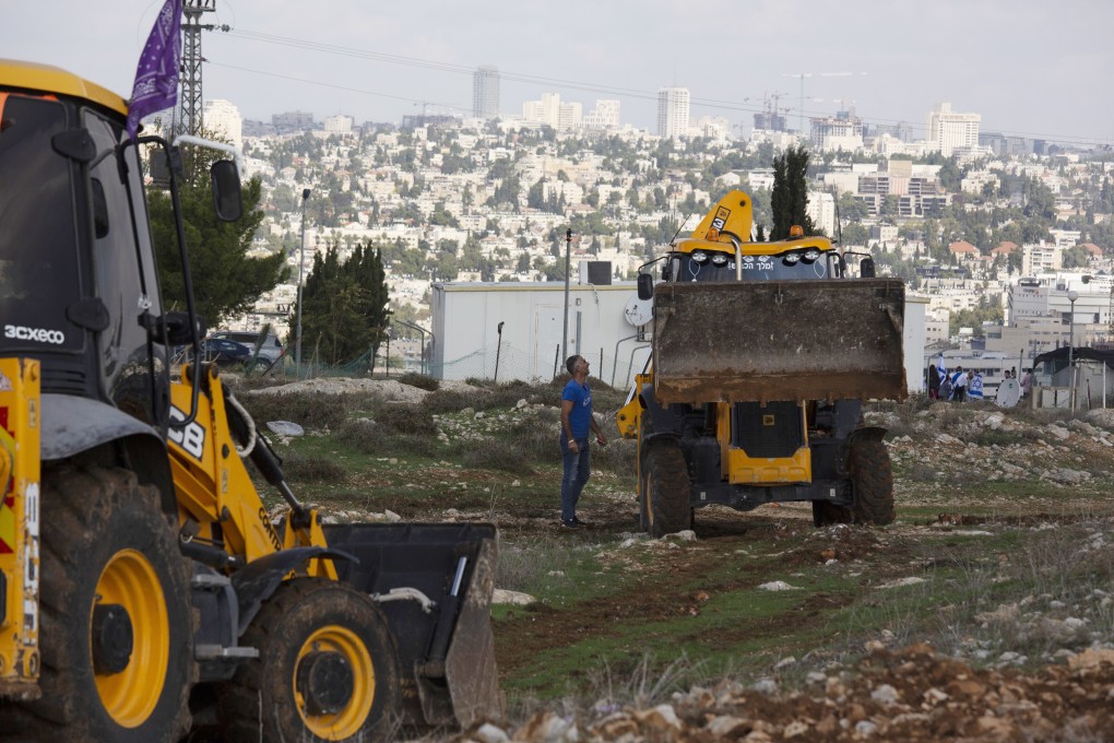 Workers take a break on a construction site for an Israeli settlement in Jerusalem. Photo: AP