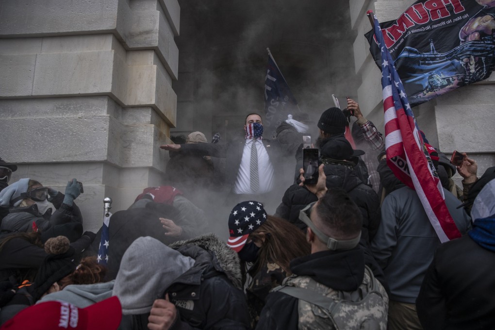 Demonstrators attempt to breach the US Capitol building on Wednesday. Photo: Bloomberg