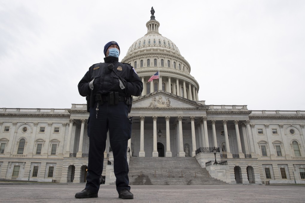 A Capitol Police officer stands in front of the US Capitol days after Trump supporters breached the grounds. Photo: EPA-EFE