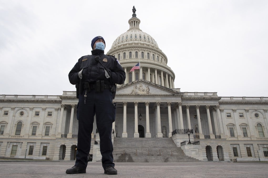 A Capitol Police officer stands in front of the US Capitol days after Trump supporters breached the grounds. Photo: EPA-EFE