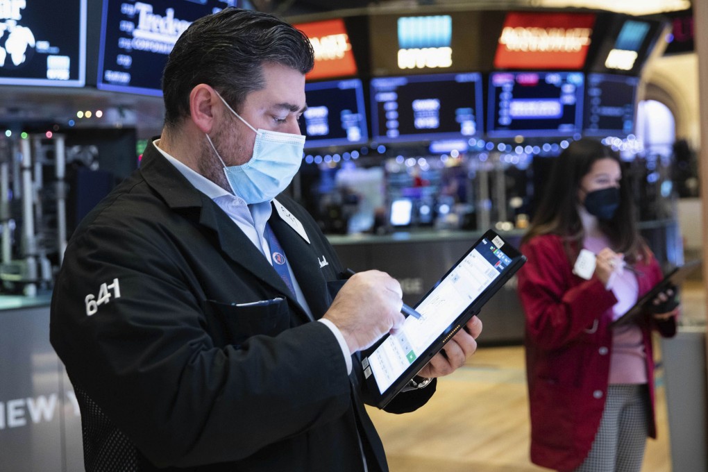Michael Capolino, left, works on the trading floor last week in New York. Photo: New York Stock Exchange via AP