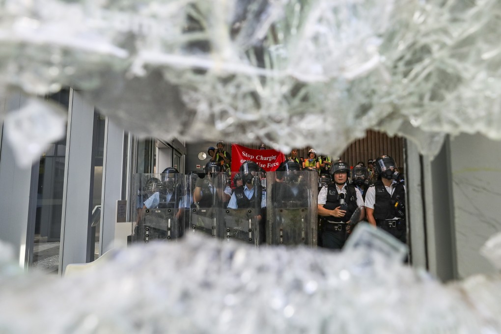 Riot police officers warn protesters to stop as the crowd smashes windows of the Legislative Council Complex in Admiralty during a protest against the extradition bill on July 1, 2019, the 22nd anniversary of Hong Kong’s return to Chinese sovereignty. Photo: Sam Tsang