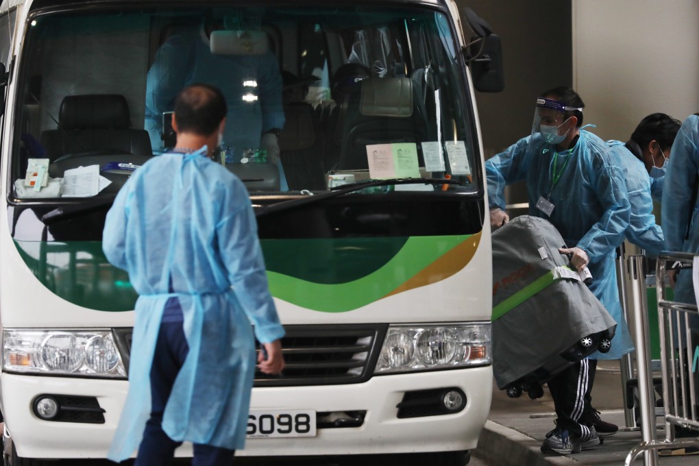 Passengers at Hong Kong airport load their luggage into a bus which will transport them designated quarantine hotels on December 22. Photo: Nora Tam