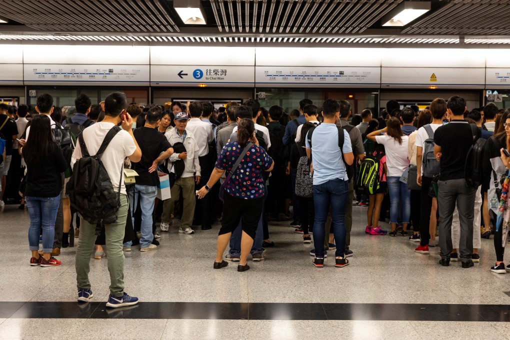 Commuters wait for an MTR train at Central Station in Hong Kong. Not having to travel to work translates to reduced exposure to roadside air pollution and less stress navigating peak-hour crowds. Photo: Bloomberg
