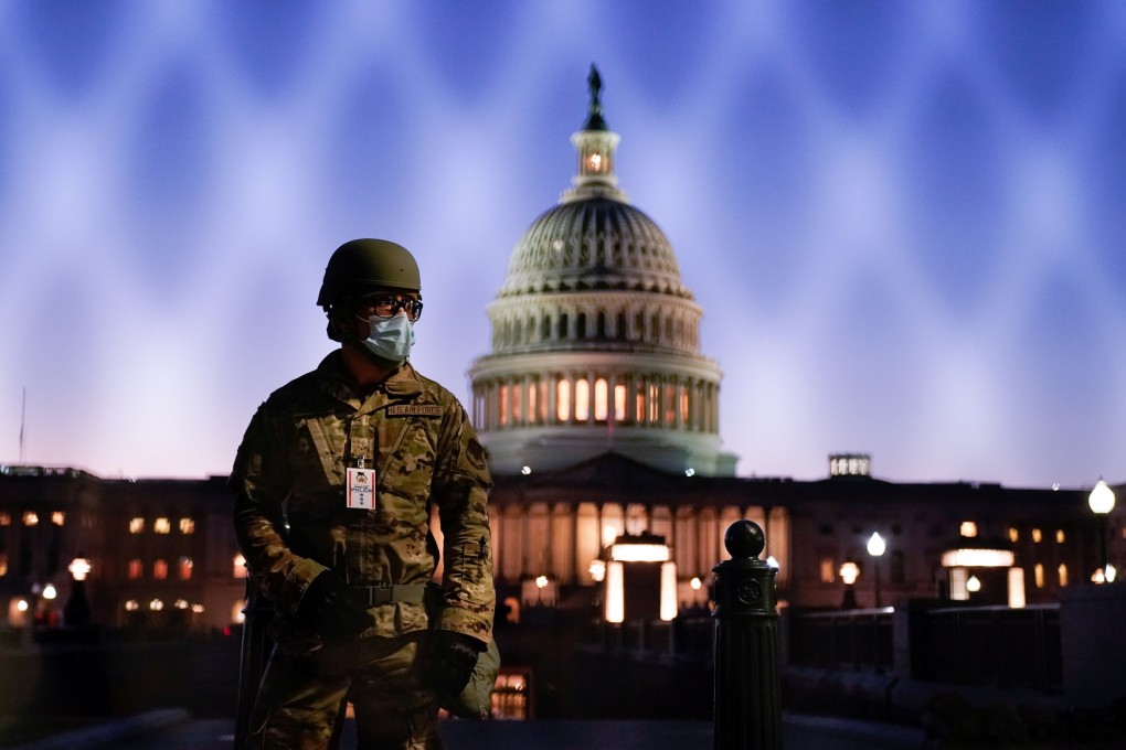 Members of the National Guard gather at the US Capitol on Tuesday as the House of Representatives prepares to begin the voting process on a resolution demanding US Vice-President Mike Pence and the cabinet remove President Trump from office. Photo: Reuters